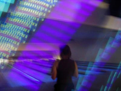 photo: blurry bowling monitors streak across a girl going to bowl