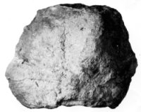 a pebble partially coated with calcite