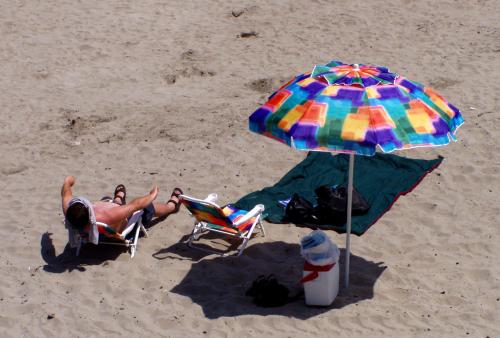 photo of some guy with a colorful beach umbrella